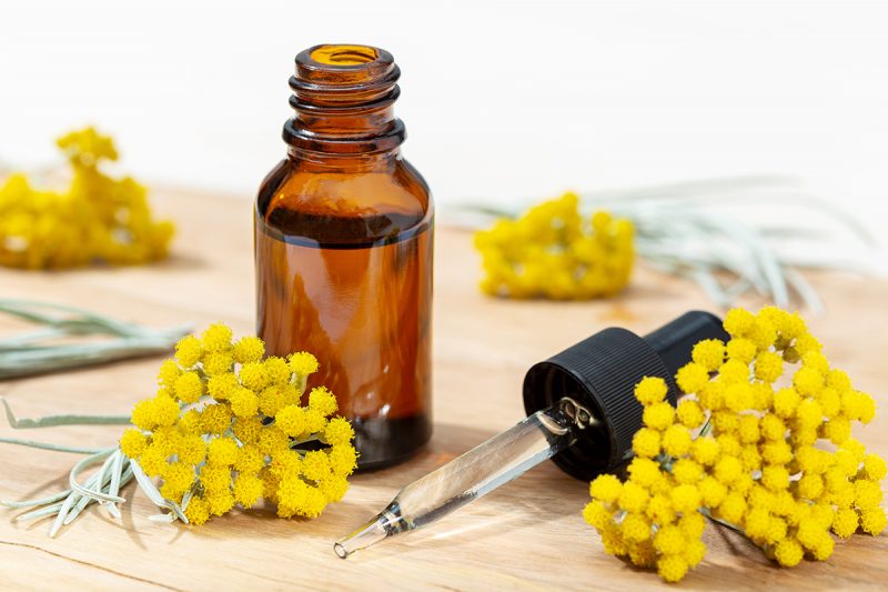 Helichrysum essential oil in amber bottle and pipette