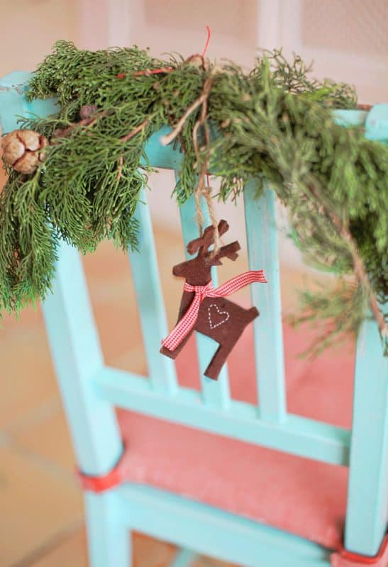 Decorate chairs with Winter foliage and Christmas ornaments