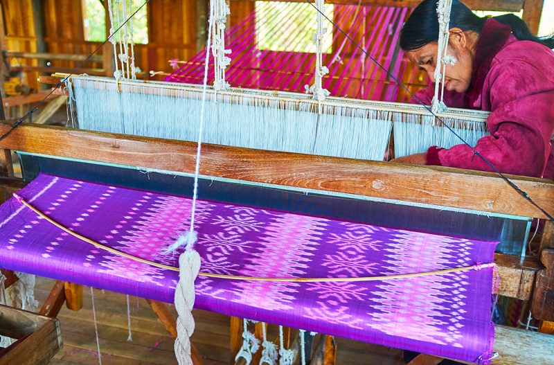 Production of silk fabric on a hand loom in a Myanmar textile workshop