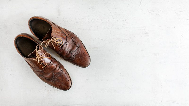 Dark brown brogue shoes, also known as wingtip Oxford shoes