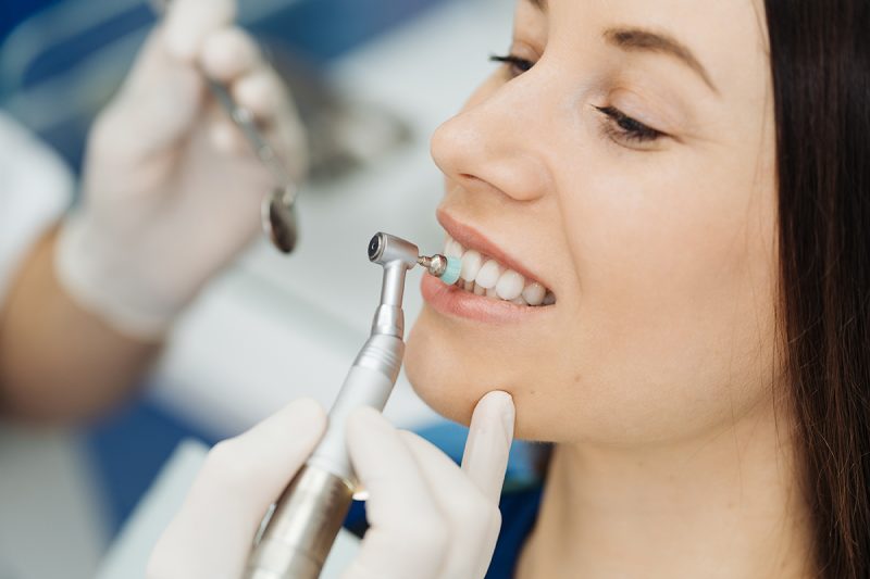 Girl at the dentist chair during a dental scaling procedure