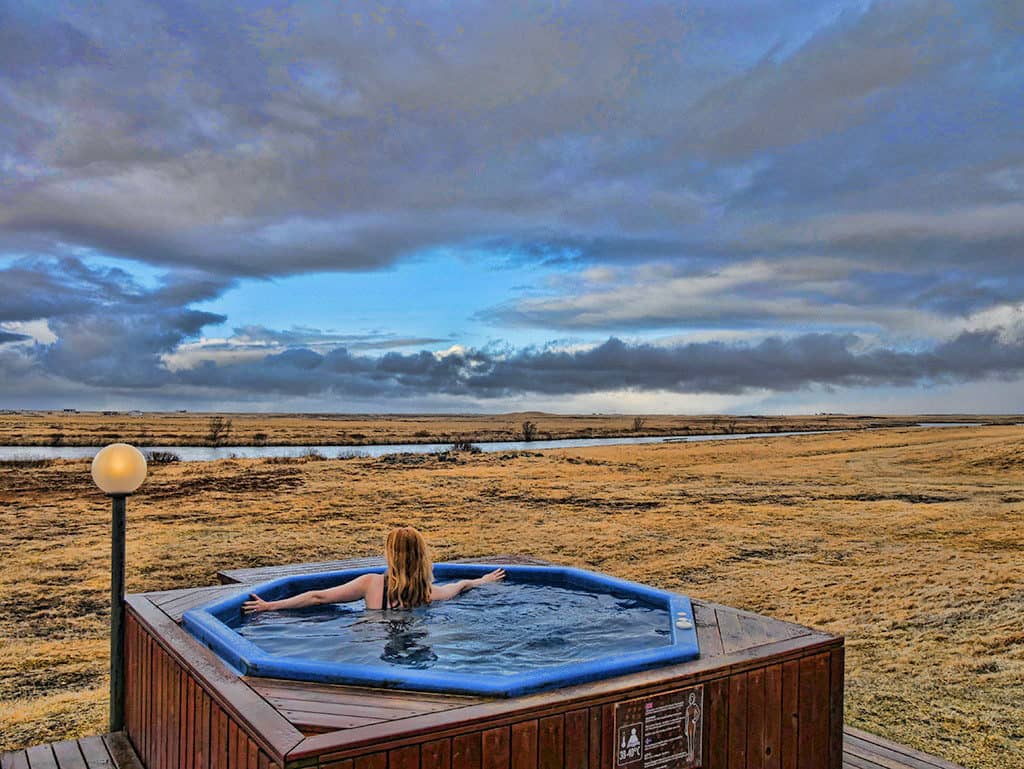 Suze enjoying the coolcation travel trend while relaxing in a hot tub in Iceland