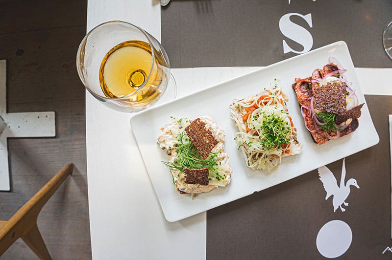 Smørrebrød with drinks in a restaurant in Copenhagen, Denmark