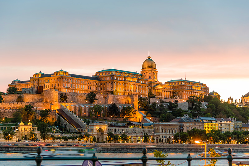 Buda Castle viewed from across the river Danube at sunset