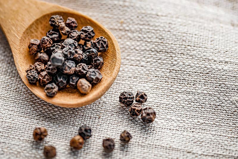 Whole black peppercorns