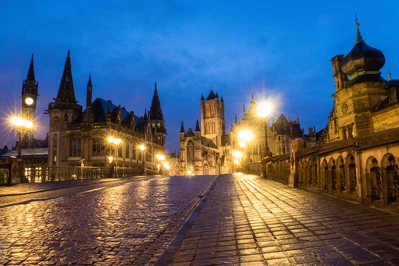 Street lamps illuminate Sint-Michielsbrug in the city of Ghent, Belgium
